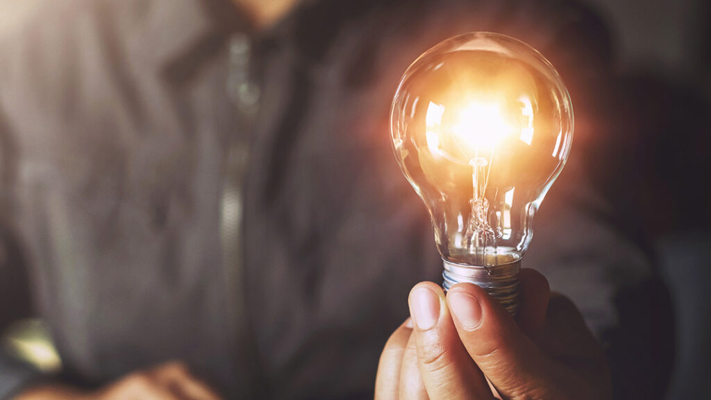 hand holding lightbulb
